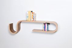 a book shelf with two books on it and a couple of books sitting on top of it