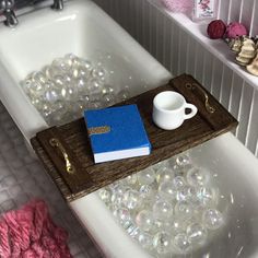 a bath tub filled with bubbles and a book