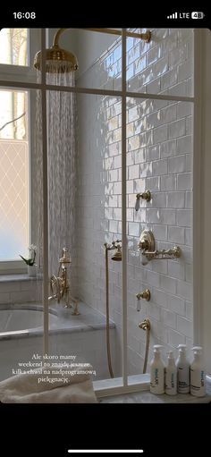 a bathroom with a tub, shower head and hand held shower faucet in it