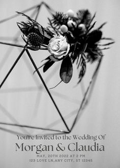 a black and white photo of a wedding card with flowers in the shape of a geometric structure