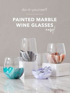 three wine glasses sitting on top of a table with the words do - it - yourself painted marble wine glasses