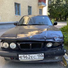 a black car is parked on the side of the road