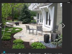 a screen shot of a patio with chairs and table in the middle, surrounded by greenery