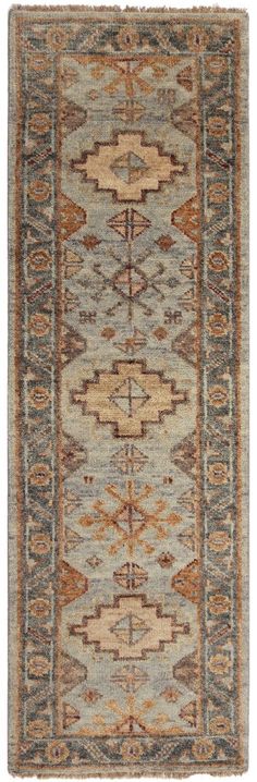 an antique rug with brown, blue and tan colors on the bottom half of it