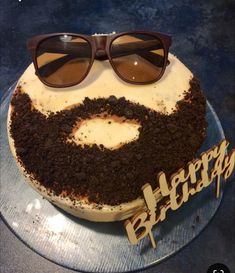 a birthday cake with sunglasses on top of it