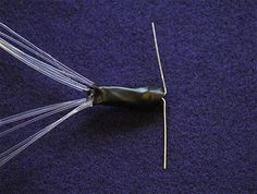 a close up of an object on a blue surface with wires sticking out of it