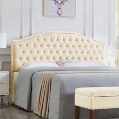 a bed with a white headboard and foot board next to a dresser in a bedroom