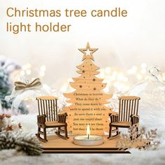 a christmas tree candle light holder with two rocking chairs and a lit candle in the middle