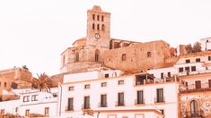 an old town with white buildings and a clock tower