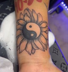 a sunflower with a ying - o tattoo on it's left arm is shown