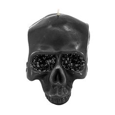 a black candle with a skull face on it