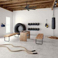 a white room with a bench, gym equipment and ceiling fan