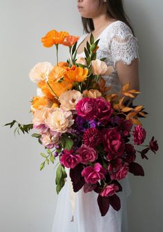 a woman holding a large bouquet of flowers