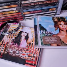 various cd's are stacked on top of each other, including one for the album