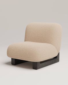 an upholstered chair with black legs and a light colored fabric covering the seat