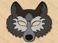 a paper mask with a wolf's face on it, in grey and black