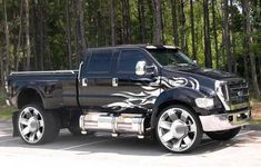 a black pickup truck with flames painted on it