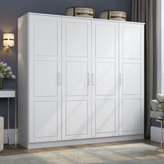 a large white cabinet in the corner of a living room with blue walls and carpet