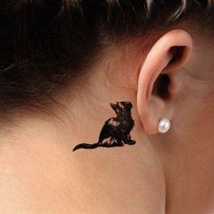 a woman's ear with a small tattoo on it