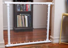 a room with a book shelf and a white mesh screen on the floor in front of it