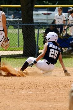 a baseball player sliding into home plate during a game