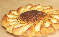 a round pastry with sprinkles on it sitting on a wooden table top