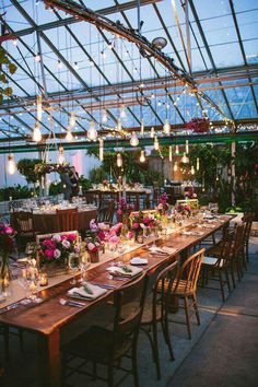 a long table is set up with flowers and candles for an outdoor dinner or party