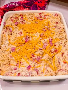 a casserole dish with shredded cheese and ham