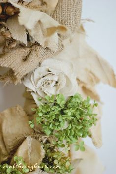 a wreath with flowers and burlocks on it