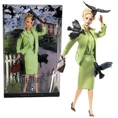 a barbie doll in a green dress and hat with black birds on her head, holding a purse