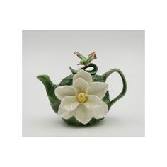 a ceramic teapot with a flower on it