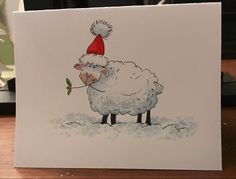 a card with a sheep wearing a santa hat