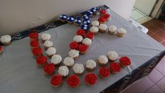 cupcakes are arranged in the shape of an x on a table