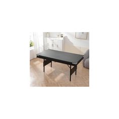 a black table sitting on top of a hard wood floor