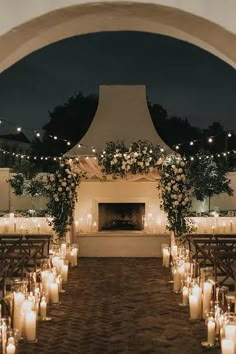 an outdoor wedding setup with candles and flowers