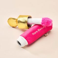 two pink and gold hair dryers sitting next to each other on a white surface