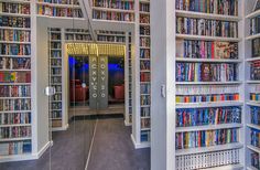 there are many bookshelves in the room with mirrors on each side and doors open