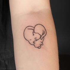 a small elephant tattoo on the arm