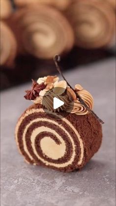 a chocolate roll with leaves and nuts on top