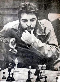 an old black and white photo of a man playing chess