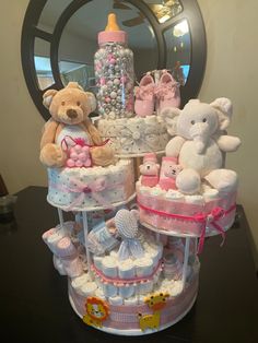 a baby shower cake with teddy bears and diapers on it's tiers