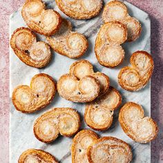 some heart shaped pastries are on a tray