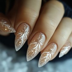 Embrace sophistication with Artistic Wonderland Nails, featuring a chic nude base accented by delicate white floral designs and golden touches. This refined December nails design adds warmth and elegance with its subtle sparkle and graceful, modern shape. Perfect for a luxurious holiday look!  #ArtisticWonderlandNails #DecemberNails #NudeAndGoldNails #ElegantNailArt #HolidayNails #ChicNailDesign #LuxuryNails #ModernNailArt Simple Nail Art Wedding, Gold And White Bridal Nails, Chrome White Nails With Design, Gold And White New Years Nails, White And Gold Nail Designs Simple, New Years Nail Designs White, White Gold Holiday Nails, Art Deco Wedding Nails, Winter Solstice Nail Ideas