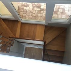 an empty room with wood paneling and skylights on the top floor is seen from above