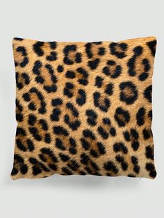 a leopard print pillow on a gray background