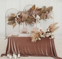 a table with flowers and feathers on it