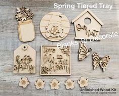 some wooden tags with flowers and butterflies on them, including one that says spring tired tray