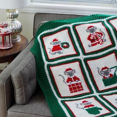 a couch with a green and red afghan on it