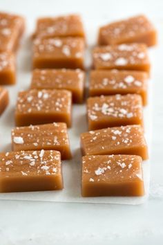 several pieces of caramel fudge on a white surface