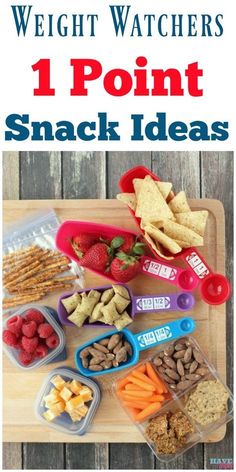 a wooden cutting board topped with containers filled with snacks and crackers on top of it